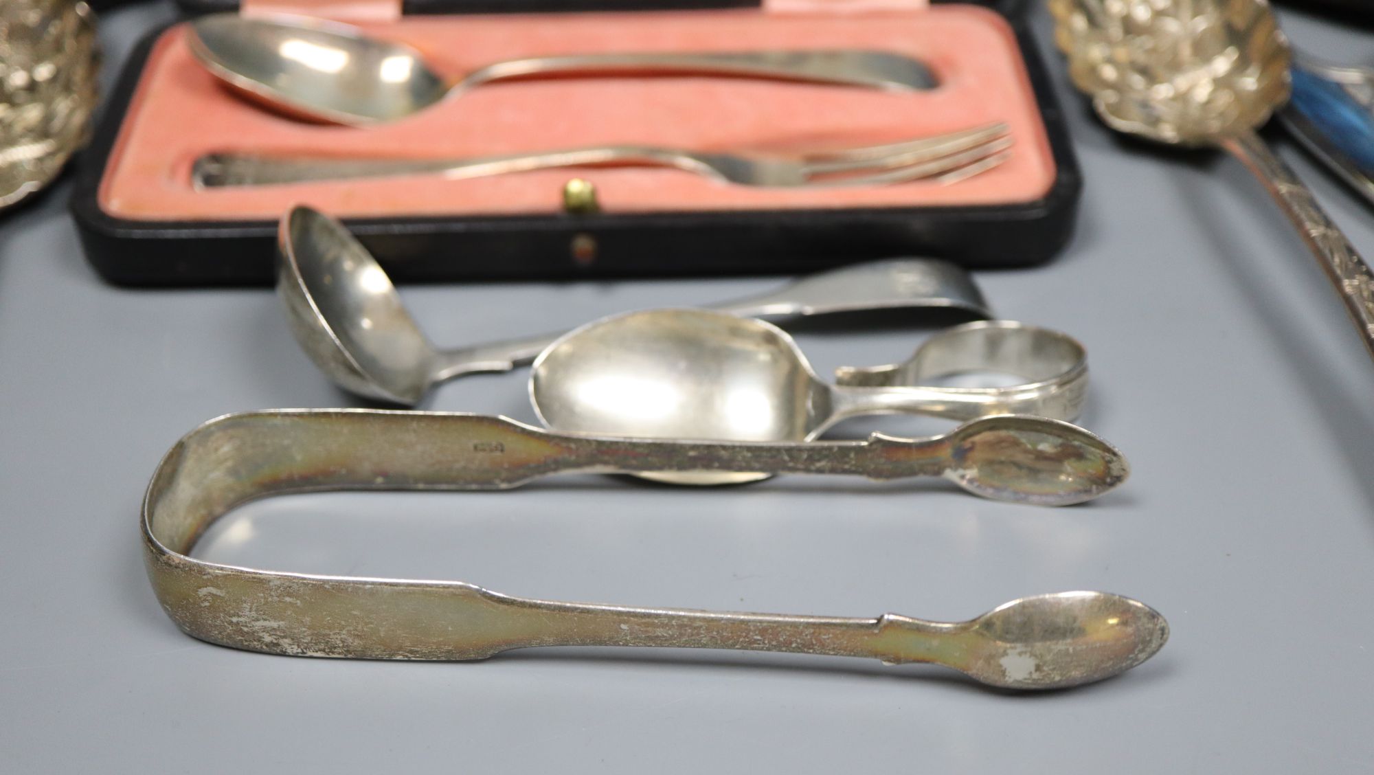 Small silver - 2 berry spoons, butter knife, ladle, feeder, christening spoon and fork. Two cased sets, tongs and a silver gilt spoon